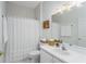 Cozy bathroom with white shower curtain and white vanity at 7253 Cleopatra Dr, Land O Lakes, FL 34637