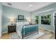 This relaxing bedroom features a metal bed frame and views of the outside greenery from the window at 7253 Cleopatra Dr, Land O Lakes, FL 34637