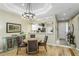 Dining area with elegant lighting and easy access to the modern kitchen at 7253 Cleopatra Dr, Land O Lakes, FL 34637