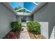 The property features a cozy entrance with a skylight roof and lush green plants at 7253 Cleopatra Dr, Land O Lakes, FL 34637