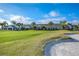 Scenic view of the golf course with the clubhouse in the distance, set against a clear blue sky at 7253 Cleopatra Dr, Land O Lakes, FL 34637