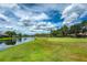 Scenic golf course with a serene lake view, surrounded by lush greenery and beautiful homes at 7253 Cleopatra Dr, Land O Lakes, FL 34637