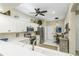 Open-concept kitchen with white cabinets, stainless steel appliances, and stylish decor at 7253 Cleopatra Dr, Land O Lakes, FL 34637