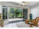 Relaxing lanai features tiled floor, a ceiling fan and sliding glass doors leading to the home's interior at 7253 Cleopatra Dr, Land O Lakes, FL 34637