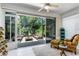 Open lanai has comfortable seating and views of the surrounding trees and landscaping at 7253 Cleopatra Dr, Land O Lakes, FL 34637