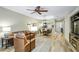 Open-concept living room with wood floors, tray ceiling, and view into dining area at 7253 Cleopatra Dr, Land O Lakes, FL 34637