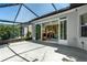 Spacious outdoor patio enclosed with glass, leading to the home's interior, great for entertaining at 7253 Cleopatra Dr, Land O Lakes, FL 34637