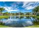 Scenic pond view with fountain, surrounded by lush greenery and neighborhood homes at 7253 Cleopatra Dr, Land O Lakes, FL 34637