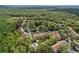 Aerial view of a garden-style apartment complex with mature trees, pool, and pond at 8612 Hunters Key Cir, Tampa, FL 33647