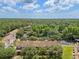 Aerial view of an apartment complex and surrounding nature preserve with pond at 8612 Hunters Key Cir, Tampa, FL 33647
