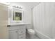 Bathroom features a vanity, large mirror, and shower-tub combo with white shower curtain at 8612 Hunters Key Cir, Tampa, FL 33647