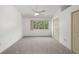 Bedroom with neutral carpet, ceiling fan and view of outdoor landscaping from the window at 8612 Hunters Key Cir, Tampa, FL 33647