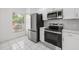 Updated kitchen featuring stainless steel appliances, white cabinets, and ample natural light at 8612 Hunters Key Cir, Tampa, FL 33647