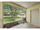 Screened lanai view of community lawn with neighboring building and utility shed at 8612 Hunters Key Cir, Tampa, FL 33647
