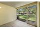 Screened lanai view of community lawn with bench and neighboring townhomes at 8612 Hunters Key Cir, Tampa, FL 33647