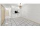 Open-concept living area with tiled flooring, modern light fixture, and a pass-through to the kitchen at 8612 Hunters Key Cir, Tampa, FL 33647