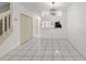 Open-concept living room with sleek tiled floors, modern lighting, and convenient kitchen access at 8612 Hunters Key Cir, Tampa, FL 33647