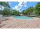 Community pool surrounded by brick pavers and lush greenery with lots of seating at 8612 Hunters Key Cir, Tampa, FL 33647