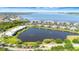 Aerial view of waterfront condos situated around scenic lake, offering picturesque community living at 915 Tidewater Shores Loop, Bradenton, FL 34208