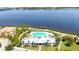 Aerial view of community pool and clubhouse overlooking a serene waterfront at 915 Tidewater Shores Loop, Bradenton, FL 34208