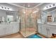 Bright bathroom featuring double vanity, a glass enclosed shower, and neutral tiles for a modern and clean design at 915 Tidewater Shores Loop, Bradenton, FL 34208