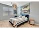 Bedroom with a Venice artwork, a modern light fixture, and a soft bed near a window with blinds at 915 Tidewater Shores Loop, Bradenton, FL 34208