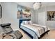 Bedroom featuring a soft bed with pillows, a modern light fixture, large wall art and a leather chair at 915 Tidewater Shores Loop, Bradenton, FL 34208