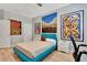 Cozy bedroom with colorful art, modern furniture, and wood floors, offering a stylish and comfortable living space at 915 Tidewater Shores Loop, Bradenton, FL 34208