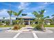 Community clubhouse in a tropical landscaped setting features well-manicured landscaping and mature palm trees at 915 Tidewater Shores Loop, Bradenton, FL 34208