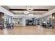 Open common area with a stone accent wall, wood beam ceiling, sliding barn door, and lots of seating at 915 Tidewater Shores Loop, Bradenton, FL 34208