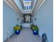 Inviting entrance with double doors, adorned with potted plants, benches, and a statue at 915 Tidewater Shores Loop, Bradenton, FL 34208