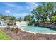 Picturesque community entrance featuring a tranquil pond, fountains, and lush landscaping at 915 Tidewater Shores Loop, Bradenton, FL 34208