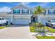 Charming townhome showcases a well-maintained exterior, lush landscaping, and inviting curb appeal under a sunny sky at 915 Tidewater Shores Loop, Bradenton, FL 34208