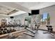 Well-equipped fitness center with free weights, weight machines, and TV, all with lots of natural light at 915 Tidewater Shores Loop, Bradenton, FL 34208