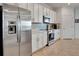 Charming kitchen features stainless steel appliances, white shaker cabinets, and tiled flooring at 915 Tidewater Shores Loop, Bradenton, FL 34208