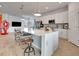 Bright open kitchen with white cabinetry, large center island and seating, flowing into an open floorplan at 915 Tidewater Shores Loop, Bradenton, FL 34208