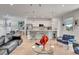 Bright living room featuring a modern open floor plan to the kitchen and white neutral decor at 915 Tidewater Shores Loop, Bradenton, FL 34208