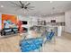 Open-concept living space with kitchen featuring a center island, stainless steel appliances, and white cabinets at 915 Tidewater Shores Loop, Bradenton, FL 34208