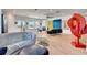 Modern living room with hardwood floors, neutral walls, and an open concept with large windows at 915 Tidewater Shores Loop, Bradenton, FL 34208