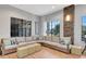 Comfortable lounge area with a large sectional sofa, modern windows, and stone accent wall at 915 Tidewater Shores Loop, Bradenton, FL 34208