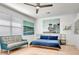 This main bedroom features neutral decor, a ceiling fan, and a queen-size bed with blue bedding at 915 Tidewater Shores Loop, Bradenton, FL 34208