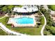 Resort-style pool and lounge area at the community clubhouse, surrounded by beautiful landscaping at 915 Tidewater Shores Loop, Bradenton, FL 34208