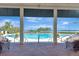 Covered outdoor seating area overlooking the beautiful community pool and scenic waterfront at 915 Tidewater Shores Loop, Bradenton, FL 34208