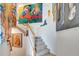 Stairway with carpeted steps, white railings, and bright modern art adorning the walls leading upstairs at 915 Tidewater Shores Loop, Bradenton, FL 34208