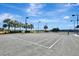 Community tennis court perfect for recreational play, surrounded by palm trees and greenery at 915 Tidewater Shores Loop, Bradenton, FL 34208