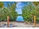 Scenic water view from the property's access point, surrounded by lush greenery under a clear blue sky at 915 Tidewater Shores Loop, Bradenton, FL 34208