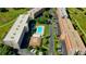 Aerial view of community featuring a pool, multiple buildings, and well-maintained landscaping at 9490 Harbor Greens Way # 303, Seminole, FL 33776