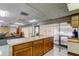 Well-lit common area featuring a full kitchen, dining tables, and a view of the pool at 9490 Harbor Greens Way # 303, Seminole, FL 33776