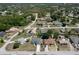 This aerial view displays homes and manicured landscaping in a suburban neighborhood at 10101 Langan St, Spring Hill, FL 34608