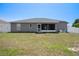 Spacious backyard with a view of the house and fenced perimeter providing privacy at 10101 Langan St, Spring Hill, FL 34608